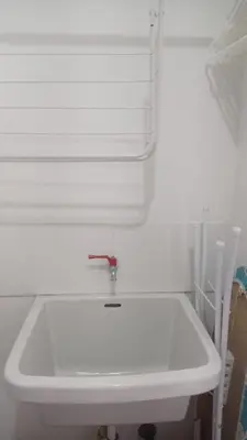 a white sink in a bathroom with a window at Departamento en Santa Catalina in Lima