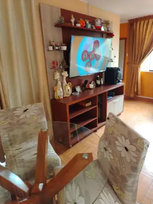 a living room with a flat screen tv on a stand at Departamento en Sjl in Lima