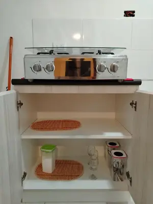 a toaster oven sitting on top of a kitchen cabinet at Depa con piscina 2025 in Lima
