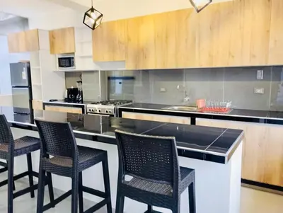 a kitchen with four chairs and a counter top at Exclusivo Depa Cerca Precio Uno para 10 in La Merced