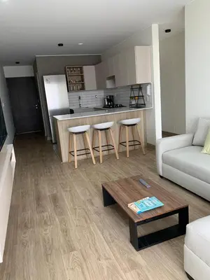 a living room with a couch and a table at Full Depa en Miraflores in Lima