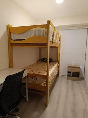 a bedroom with two bunk beds and a desk at Departamento de Estreno in Lima