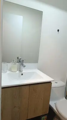 a bathroom with a white sink and a toilet at Departamento de Estreno in Lima