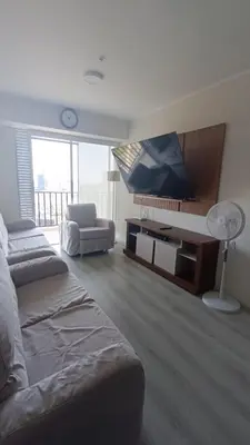 a room with two beds and a flat screen tv at Departamento de Estreno in Lima