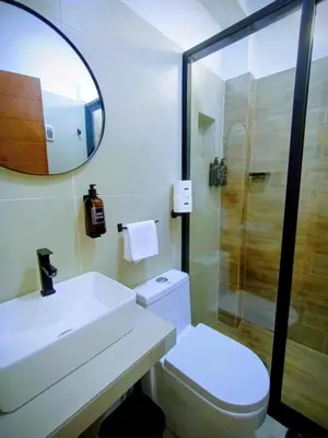 a bathroom with a sink and a toilet and a mirror at Hotel Costa Arena in Supe