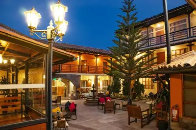 a courtyard with a tree in front of a building at Union Hotel Cusco in Cusco