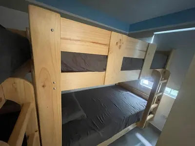 a couple of bunk beds in a room at Casa de Playa Hawi in San Antonio