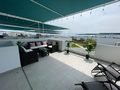 a balcony with a couch and chairs on a building at Casa de Playa Hawi in San Antonio