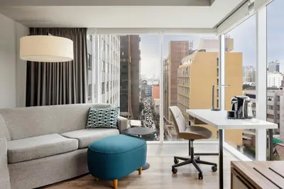 a living room with a couch and a table at Courtyard by Marriott Lima Miraflores in Lima