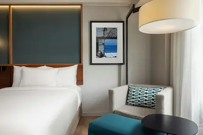 a hotel room with a bed and a chair at Courtyard by Marriott Lima Miraflores in Lima