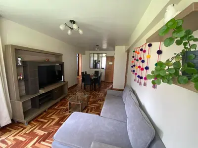 a living room with a couch and a television at Family-friendly apartment! in Cusco