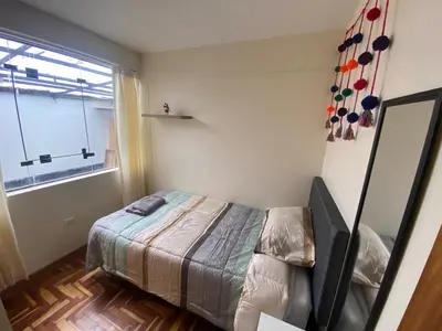 a small bedroom with a bed and a window at Family-friendly apartment! in Cusco