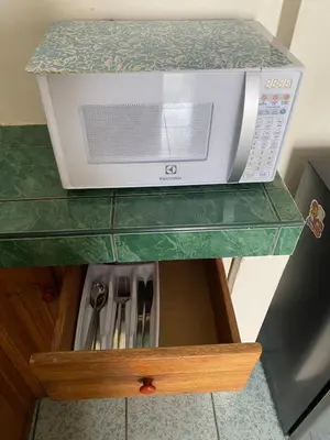 a microwave oven sitting on top of a shelf at Family-friendly apartment! in Cusco