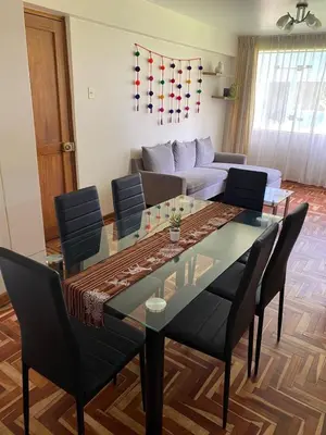 a dining room with a glass table and chairs at Family-friendly apartment! in Cusco