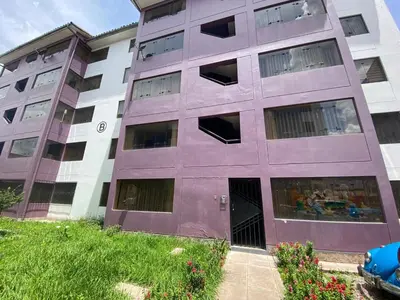 a purple building with its door open in a yard at Family-friendly apartment! in Cusco