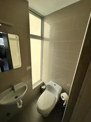 a bathroom with a white toilet and a sink at Miraflores Mini Apartment in Lima