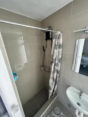 a bathroom with a shower and a sink at Miraflores Mini Apartment in Lima