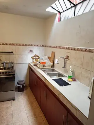 a kitchen with a sink and a stove at Casa Halcones Huachipa Familia & Eventos in Lima