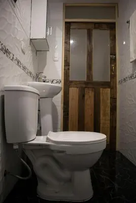 a white toilet and a sink in a bathroom at La Almudena hogar tranquilo y acogedor in Cusco