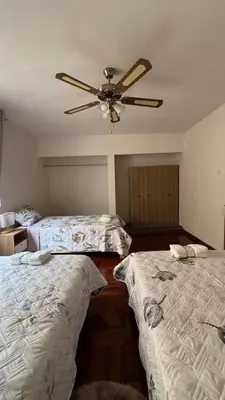 a bedroom with two beds and a ceiling fan at Casa Amplia en Miraflores in Lima