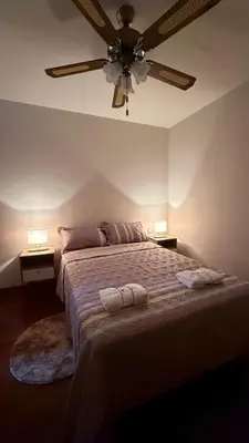 a bedroom with a bed with a ceiling fan at Casa Amplia en Miraflores in Lima
