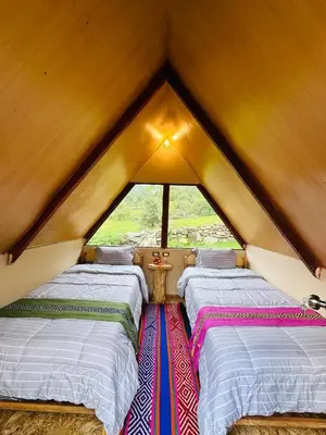 a group of three beds sitting in a room at Salkantay Glamp in Colcapampa