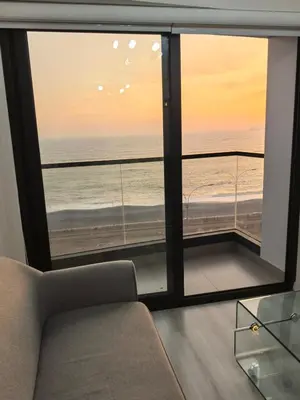 a living room with a view of the ocean at Elegante Departamento vista al mar en Lima in Lima