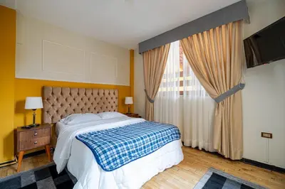 a bedroom with a bed and a large window at Classy Andino & primer piso, 2 dormitorios in Lima