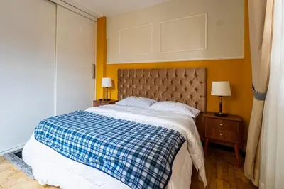 a bedroom with a bed with a blue and white blanket at Classy Andino & primer piso, 2 dormitorios in Lima