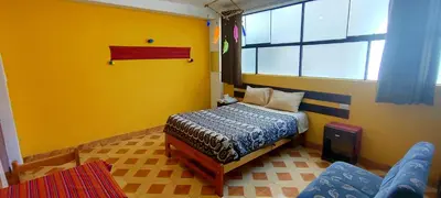 a small bedroom with a bed and a window at Mountainview House Ollantaytambo in Ollantaytambo