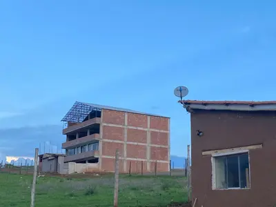a brick building in a field next to a house at Casa Moriáh in Maras