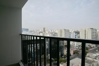 a balcony with a view of a city at Aguirre By Wynwood House in Lima