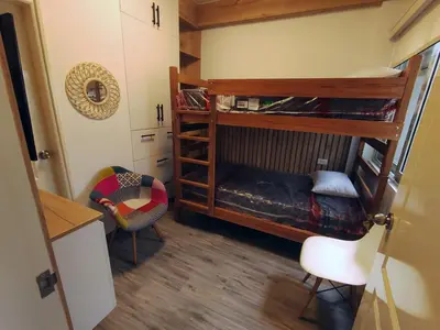a room with two bunk beds and a chair at Casa de playa Bujama, Mala, Asia, Lima, Moravia II in Bujama Baja
