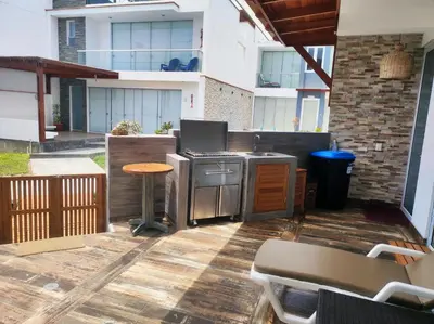 an outdoor patio with a stove and a table at Casa de playa Bujama, Mala, Asia, Lima, Moravia II in Bujama Baja
