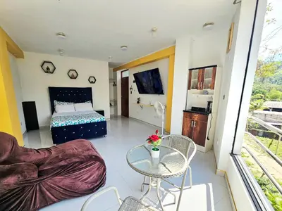 a room with a bed and a couch and a table at PIERO HOUSE - La Merced in La Merced