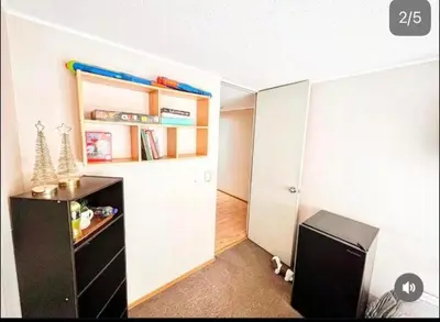 a small room with a black dresser and a closet at Katari Home Peru in Lima