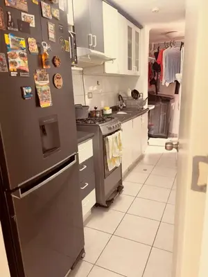 a kitchen with a stainless steel refrigerator with magnets at Katari Home Peru in Lima
