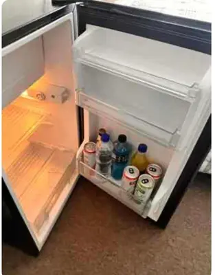 an open refrigerator with drinks and sodas in it at Katari Home Peru in Lima