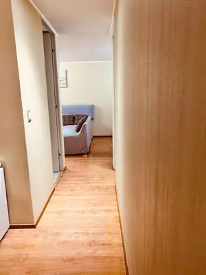 a hallway leading to a bedroom with a bed at Katari Home Peru in Lima