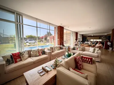 a large living room with couches and a large window at Casa Chocaya Playa Campo in Fundo Copacabana