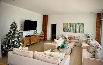 a living room with a christmas tree and a couch at Casa Chocaya Playa Campo in Fundo Copacabana