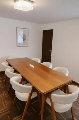 a conference room with a wooden table and chairs at Bello departamento frente a Larcomar Miraflores in Lima