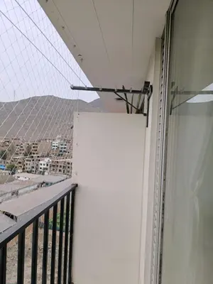 a balcony with a white wall and a view at apartment Campoy for tourist in Lima