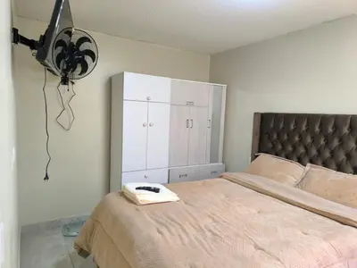 a bedroom with a bed with a phone on it at apartment Campoy for tourist in Lima