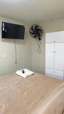 a bedroom with a bed with a television on the wall at apartment Campoy for tourist in Lima
