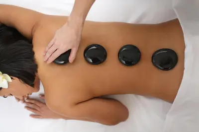 a woman laying on a bed with a massage at InterContinental Real Lima Miraflores by IHG in Lima