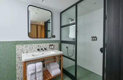 a bathroom with a sink and a shower at Hotel Indigo Lima Miraflores by IHG in Lima