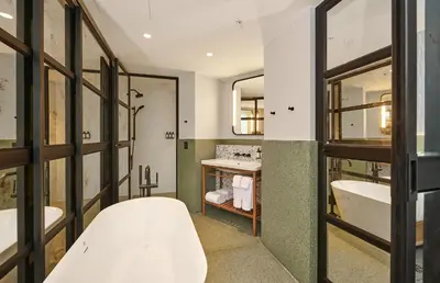 a bathroom with two sinks and a tub at Hotel Indigo Lima Miraflores by IHG in Lima