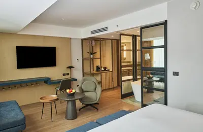 a hotel room with a couch and a tv at Hotel Indigo Lima Miraflores by IHG in Lima