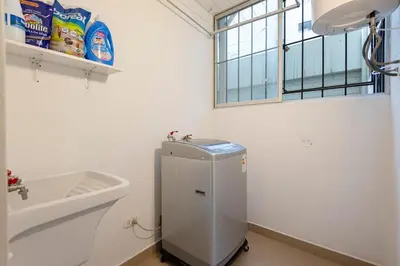 a bathroom with a sink and a toilet and a window at GRM302 Apt Moderno 2 DRM with KING Bed in Miraflores in Lima